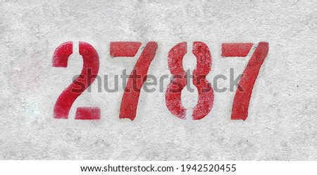 Red Number 2787 on the white wall. Spray paint.