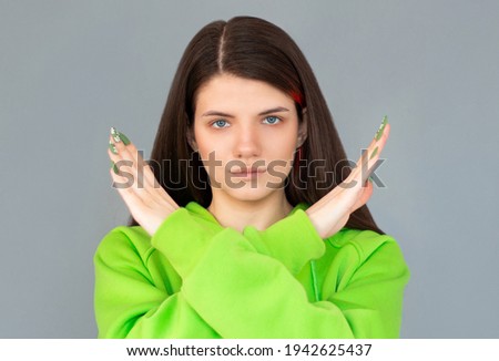 Close up photo amazing beautiful lady straight long hair arms hands crossed not allow violence stop war make love calling wear casual t-shirt outfit clothes isolated gray light background Royalty-Free Stock Photo #1942625437