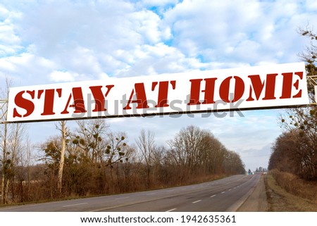 An inscription on a large billboard in the middle of the road: "Stay at home"!