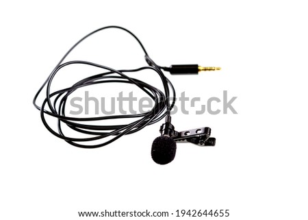 Small lavalier microphone or lapel mic with clip on white background. Professional sound recording equipment for cell phone.