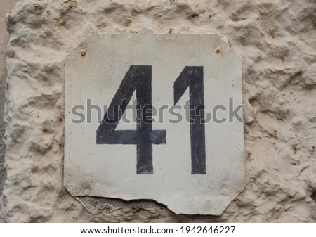 A sign on a wall with the number forty-one-41