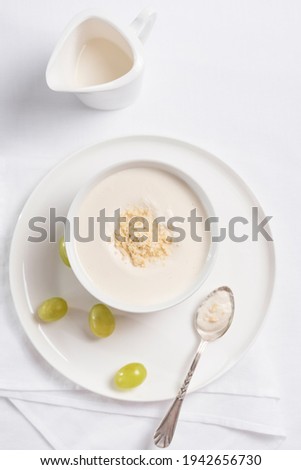 Almond cream with grapes, Spanish cold soup, White Garlic on a white table. Top view