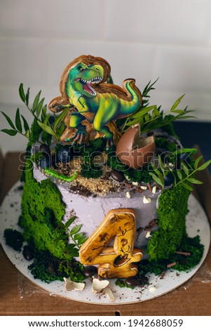 green dinosaur cake for four-year-old baby boy with moss and egg