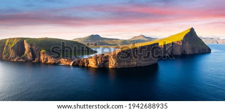 Aerial view from drone of Sorvagsvatn lake on cliffs of Vagar island in sunset time, Faroe Islands, Denmark. Landscape photography panorama Royalty-Free Stock Photo #1942688935