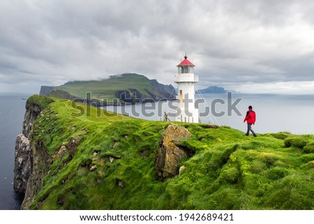 Foggy view of old lighthouse on the Mykines island, Faroe islands, Denmark. Landscape photography