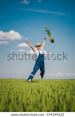 Happy farmer in the wheat