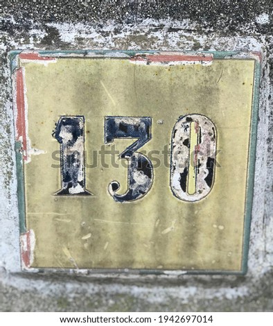 Old house number on a sunny day