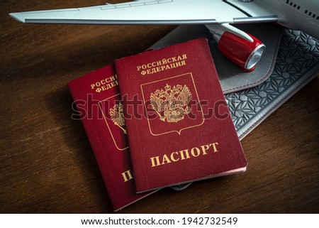 Russian foreign passport next to the wing of the plane
