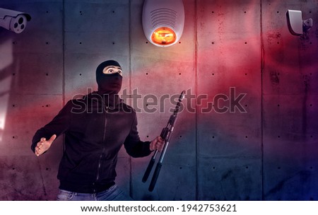 Thief with balaclava and wire cutter was spotted trying to steal in a apartment from the security alarm system. Scared expression Royalty-Free Stock Photo #1942753621