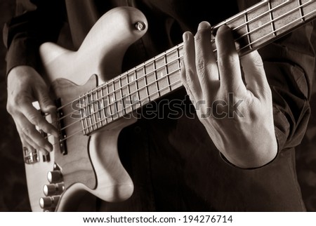 bassist playing jazz bass,sepia picture