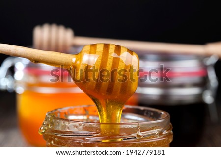 several varieties of honey from different varieties of flower plants, bottled in different jars several different types of honey that differ in color, taste and other characteristics, flower honey