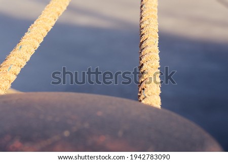 A close-up rope in sunlight with a blurry background.