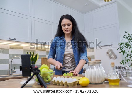 Woman recording recipe for making apple pie