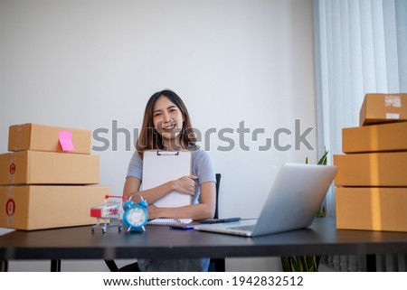 Small business entrepreneur SME freelance,Portrait young woman working on laptop at home office, online marketing packaging delivery box, SME e-commerce concept