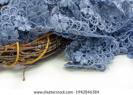 Gray-blue lace ribbon. wide floral pattern, colorful lace fabric, gift wrapping and flower decoration
