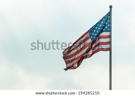 American flag on the sky background