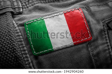 Tag on dark clothing in the form of the flag of the Italy.