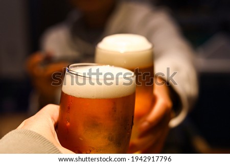 Cheers for a glass of beer with a friend.