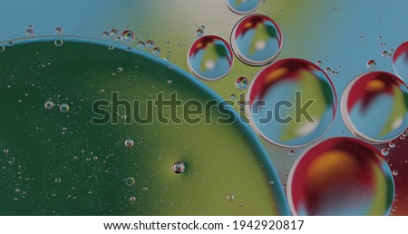 Oil bubbles on water abstract form in glass tank