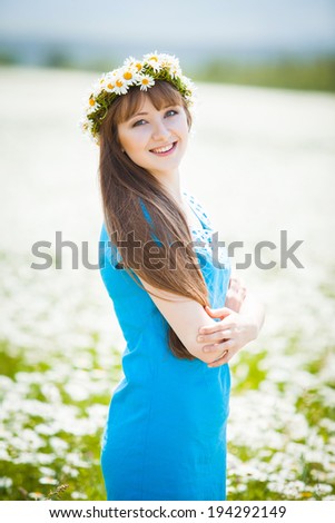 Beautiful Young Woman Outdoors in Camomile Field. Enjoy Nature. 