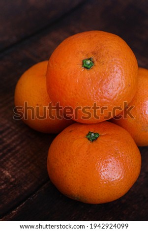 Tangerines on a dark wooden table