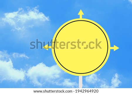 Road​ sign​ with​ 3​ arrow​s​ All​ with​ yellow, black​ border​ lines, Clouds​ against​ a​ clean​ blue​ sky.