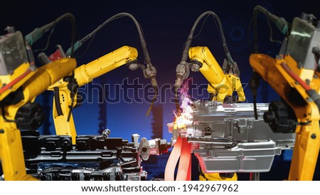 Smart industry robot arms modernization for digital factory technology . Concept of automation manufacturing process of Industry 4.0 or 4th industrial revolution and IOT software control operation .