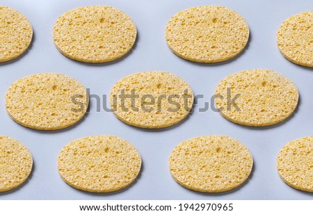 Yellow sponges fopr face on the blue surface.Beauty background