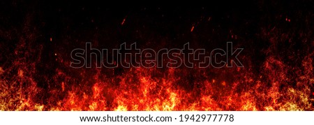 Blurred fire embers over black background. Fire sparks background. Abstract dark glitter fire particles lights. bonfire in motion blur. Royalty-Free Stock Photo #1942977778