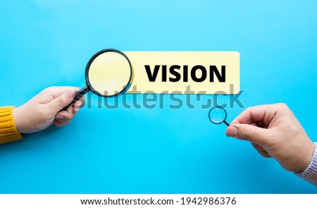 Business vision and analysis concepts with person hand and magnifying.education or planning 