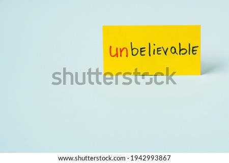 The inscription on the sticker: "UNBELIEVABLE" cut in half on an blue background