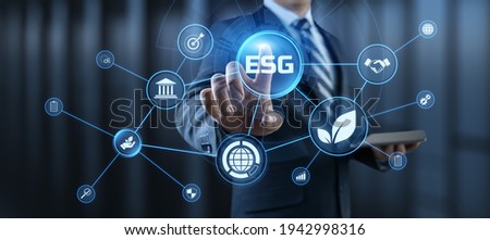 ESG environmental social governance business strategy investing concept. Businessman pressing button on screen. Royalty-Free Stock Photo #1942998316