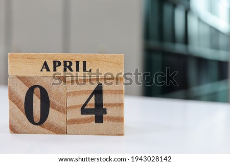 Day 4 of April month, Wooden calendar with date on table in the library.