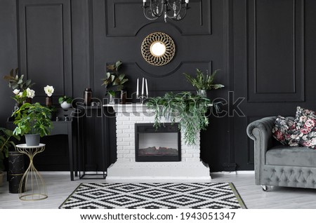 luxury interior decor black wall with white brick fireplace, gold frame and gray sofa. classic black dining room style