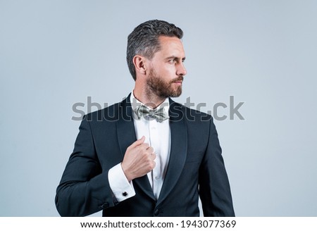 confident and successful man in tuxedo bow tie on formal event, esthete
