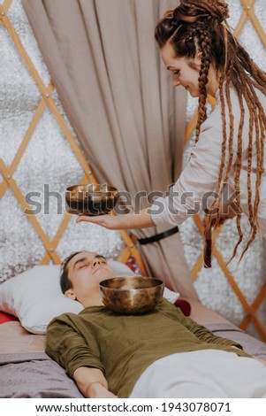 Professional ayurvedic specialist happy for the treatment done to the patient. Stress management therapy deep relaxation in music sound therapy provided by professional in private spa clinic concept