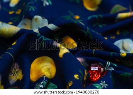 Cotton, blue background with a print of bunnies and fruits. The jersey fabric is so named because it was first produced in the Middle Ages on the Channel Island of Jersey.