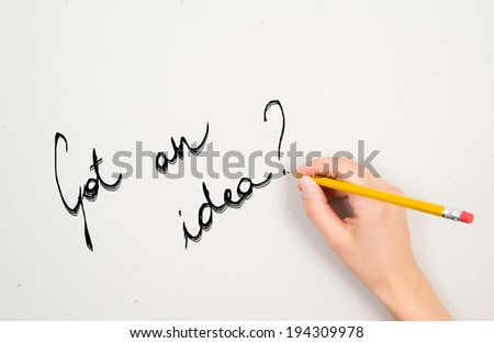 a woman's hand is writing a question  with a pencil on a white sheet of paper
