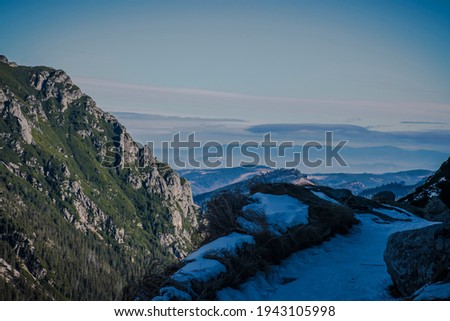 Panoramic view of lower hills and and Pieniny Mountain Range seen from Tatra National Park, Poland. Selective focus on the rocks, blurred background.