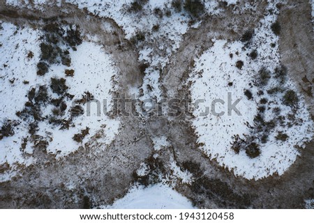 Beautiful snow-covered landscape of the winding river floodplain in winter. Amazing textures of nature. Eastern Europe. Aerial photography