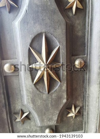 Close up of star studs on an old wooden door. High quality photo