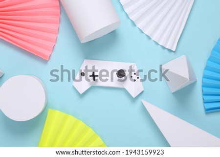 Origami gamepad on abstract background with geometric shapes. Minimalism. Concept art. Creative layout