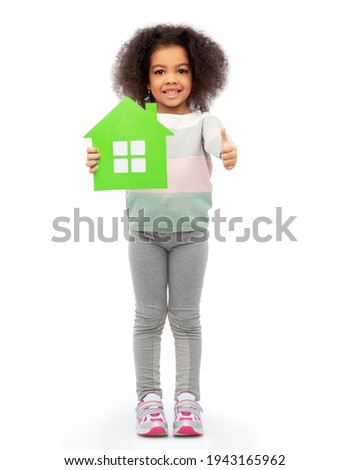 smiling african girl holding green house icon
