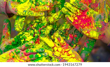 Hands of young people with Indian dyes on Holi color festival. Holi or Dhulandi color festival of India.