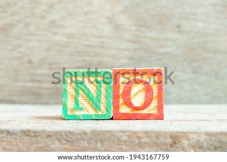 Color alphabet letter block in word no on wood background
