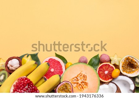 Different exotic fruits on beige background, flat lay. Space for text