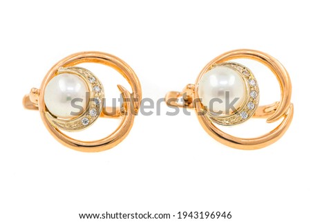 Gold earrings with pearls. Jewelry close-up isolated on white background. Bijouterie