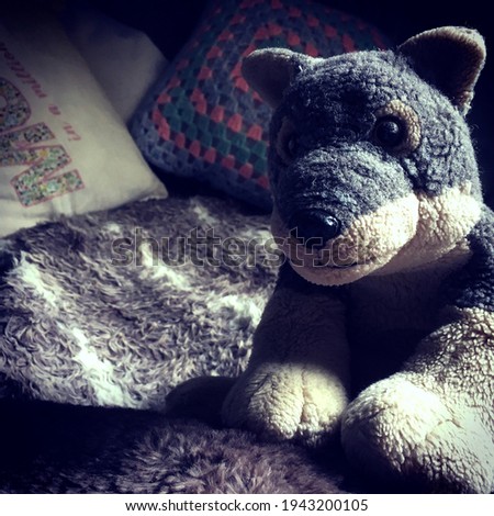 Picture of a Wolf plushie soft toy taken on a soft blanket