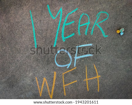 The inscription text on the grey board, 1 year of WFH (work from home). Using color chalk pieces.