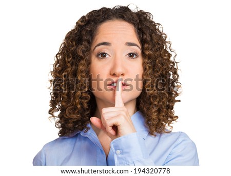 Secret woman. Female showing hand silence sign, making shushing gesture holding her index finger to lips isolated white background. Human face expressions, body language, reaction, life perception
